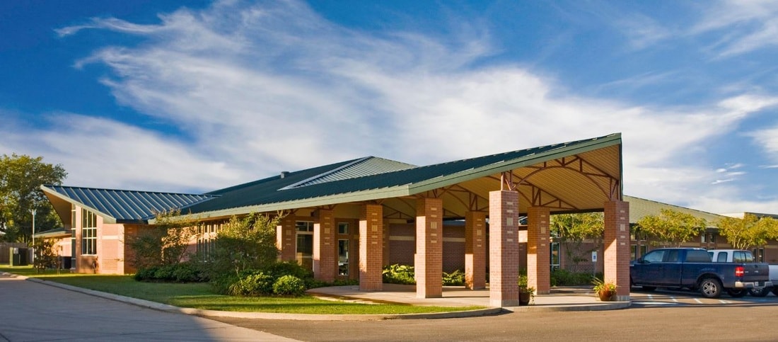 Brick building wide entrance with metal roof canopy