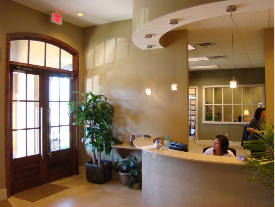 Medical clinic reception lobby with curved desk and pendant lighting