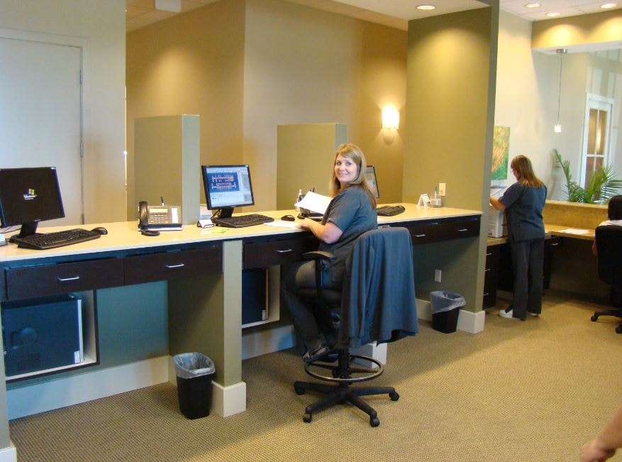 Dental office workstation with staff at computer desks