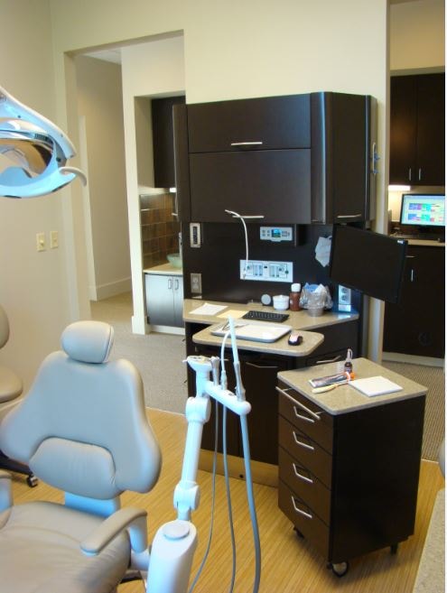 Dental operatory with treatment chair and dark cabinetry