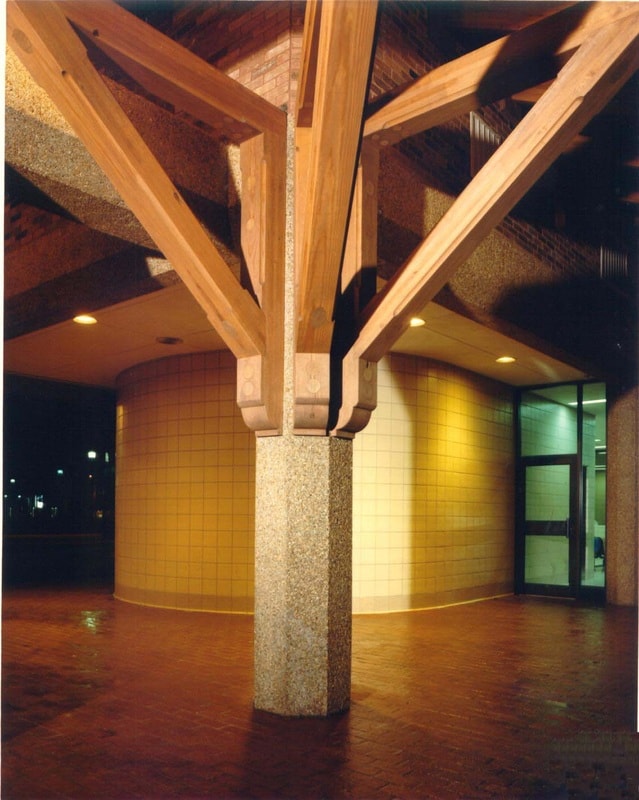 Modern building interior with wood beams and concrete column at night